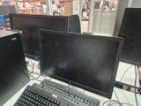 two computer monitors and a keyboard on the desk