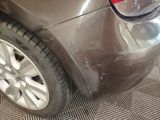 a close up of a car ' s rear end with a tire