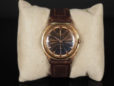 une photo d'une montre posée sur un oreiller, sur une table
