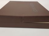 a brown box that is open on a white table