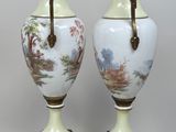 pair of antique porcelain vases with handles on stands on a white background