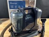 a close up of a vacuum cleaner on a table with a box