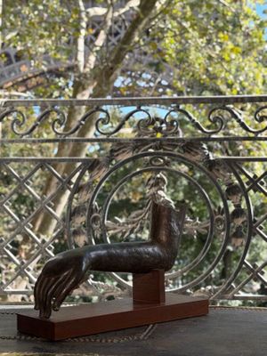 a statue of a horse on a table in front of a window