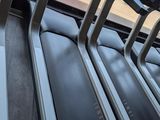row of treads in a gym room with a view of the outside