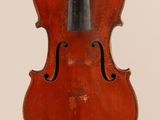 an old violin sitting on top of a white surface