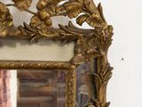 a mirror hanging on the wall with a person taking a picture