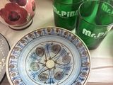a plate with a clock on it sitting on a table