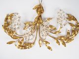 an image of a gold leaf and flower brooch on a white background
