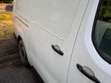 a white van that is parked on the side of the road
