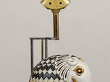 a white elephant statue with a gold and black design on it