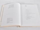 an open book on a white table with a white background