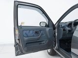 a door open of a car that is sitting on a tile floor