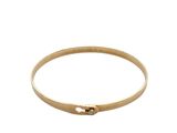 a close up of a gold bang bracelet with a single diamond