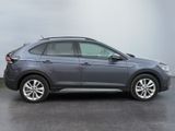 the grey volkswagen suv is parked in a parking lot