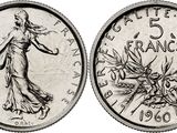 a close up of a coin with a drawing of a woman on it