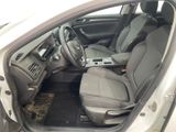 the interior of a car with the door open and the driver ' s seat down