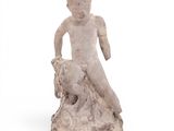 statue of a boy on a rock with a dog