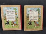 two books of children ' s books are sitting on a black surface