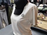 a mannequin with a hat on a table in a clothing store