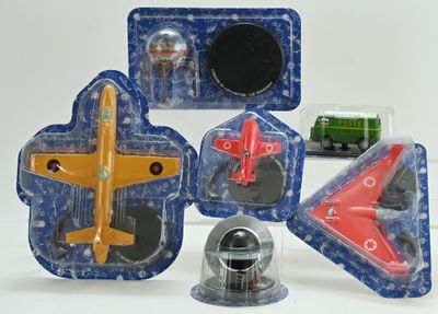 four different toy airplanes in the packaging on the table
