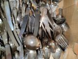 a box full of silverware and spoons in it