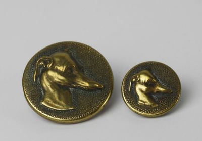 pair of antique brass buttons with dog heads on them