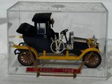 a small toy car in a clear box on a white surface