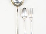 a spoon, fork, and spoon rest on a white surface
