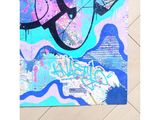 painting of a blue, pink, and purple abstract painting on a wood floor