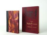 two books sitting on top of each other on a white surface