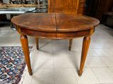 a wooden table with two chairs and a rug on the floor