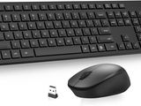 keyboard and mouse on a white surface next to each other