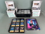 a lot of cards and a box of games on the table