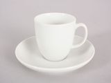 a white cup and saucer sitting on a saucer