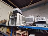 many electronic equipment on a shelf in a room