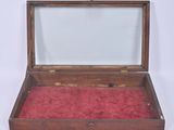 a small wooden box with a red velvet inside