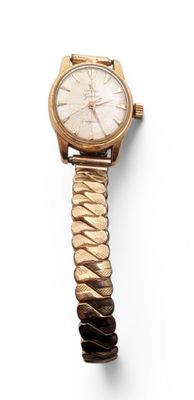 an image of a gold wrist watch with a chain around it