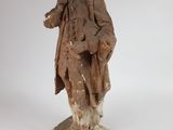 an old statue of a man with a coat on a white background