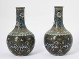two vases sitting side by side on a white surface