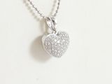 a close up of a heart shaped pendant on a chain