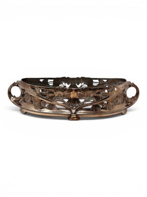 a large bronze tray with a flower design on the bottom