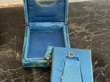 a small blue box with a ring inside of it