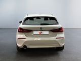 the rear of a white bmw car parked in a room