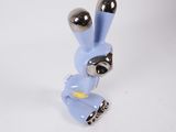 a blue bunny figurine that is sitting on a white surface