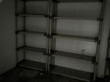 a room with a shelf and a toilet in it