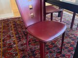 a red chair sitting in front of a black table