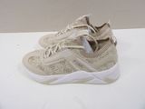 beige sneakers with white soles on a white surface