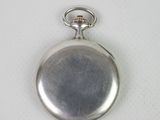 a small silver pocket watch on a white surface