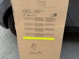 a cardboard box sitting on the ground next to a car