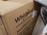 a box of whirlpool sitting on top of a pile of other boxes